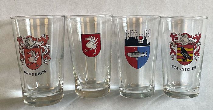 small white wine glasses featuring various nearby town outside of Lausanne (author’s collection)